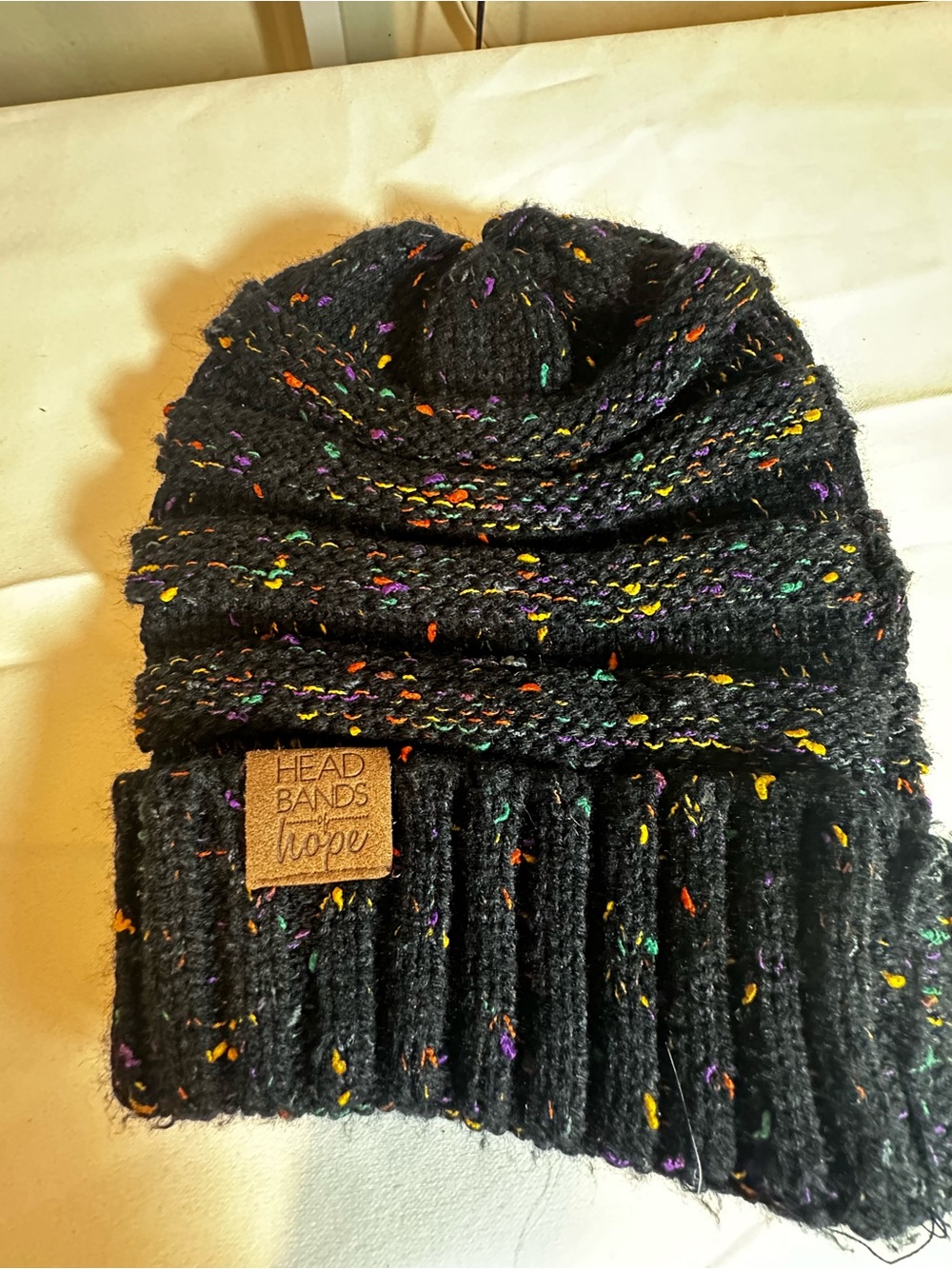 A29. Headbands of Hope Black Speckled women’s Knit Beanie